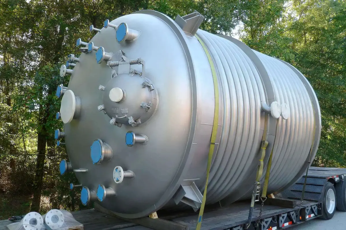 Industrial storage tank featuring custom GRP/FRP fittings, nozzles, and manways for specialized chemical processing by Global Fiberglass Company.