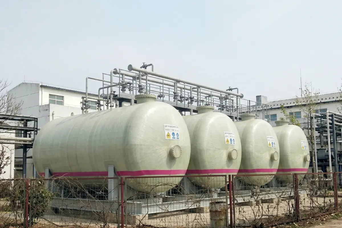 Large horizontal cylindrical FRP storage tanks installed at an industrial chemical plant by Global Fiberglass Company.