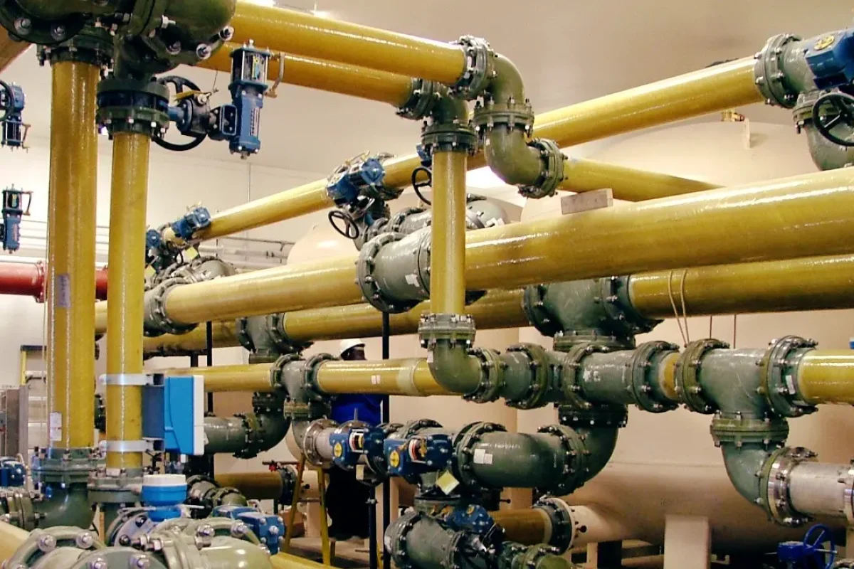 Industrial FRP piping systems with precision-engineered yellow pipelines installed in a chemical processing facility.