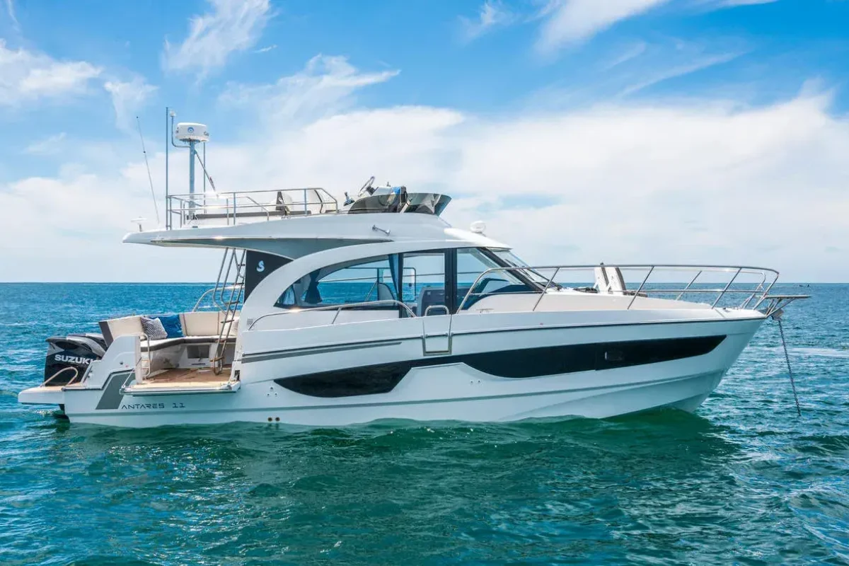 Luxury white motor yacht cruising on the ocean, featuring high-quality GRP composite hull and structural fabrication by Global Fiberglass Company.